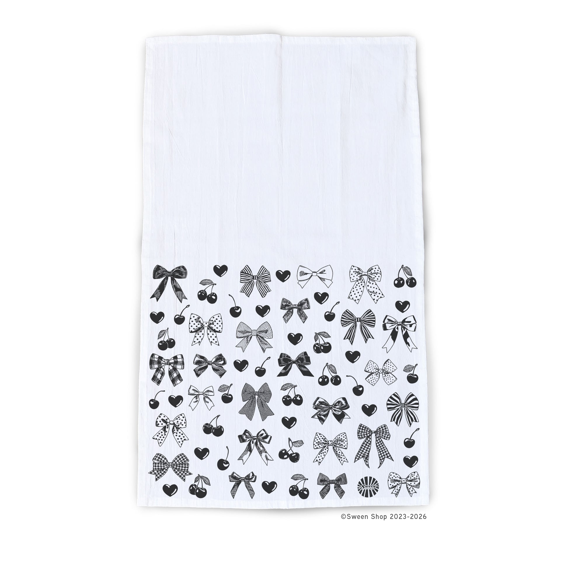 White kitchen towel with black bow cherries and heart pattern on a white background