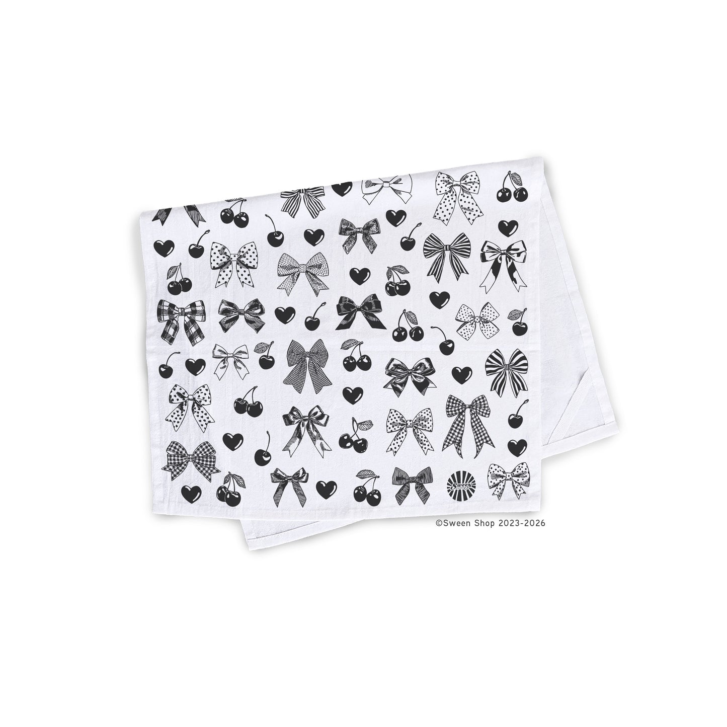 White cotton kitchen towel with black bow heart and cherry pattern on a white background