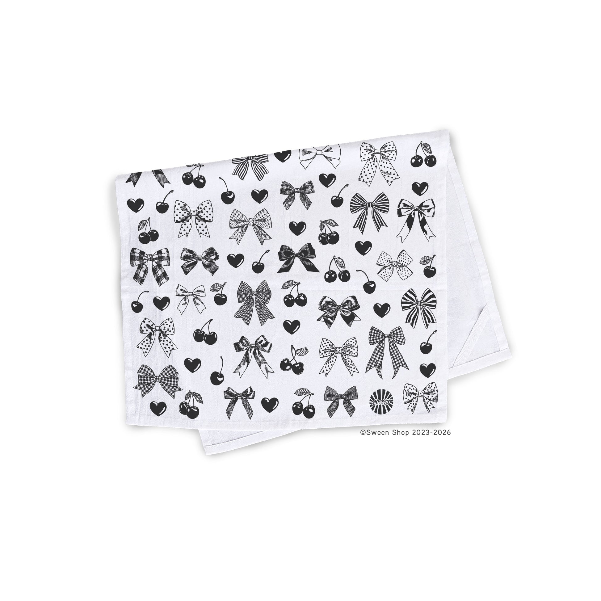 White cotton kitchen towel with black bow heart and cherry pattern on a white background