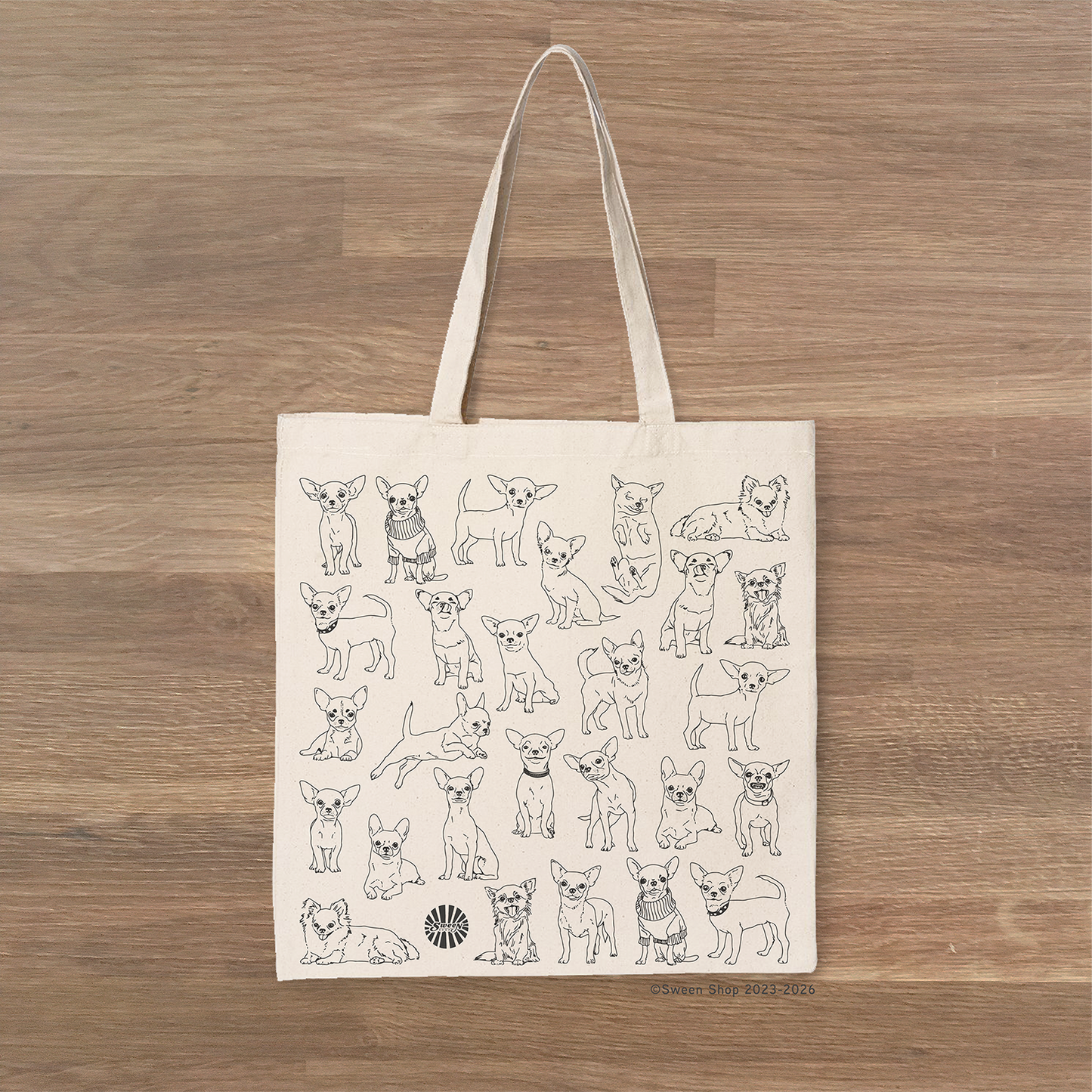 beige cotton canvas Tote bag with chihuahua pet dog illustrations on a wooden surface
