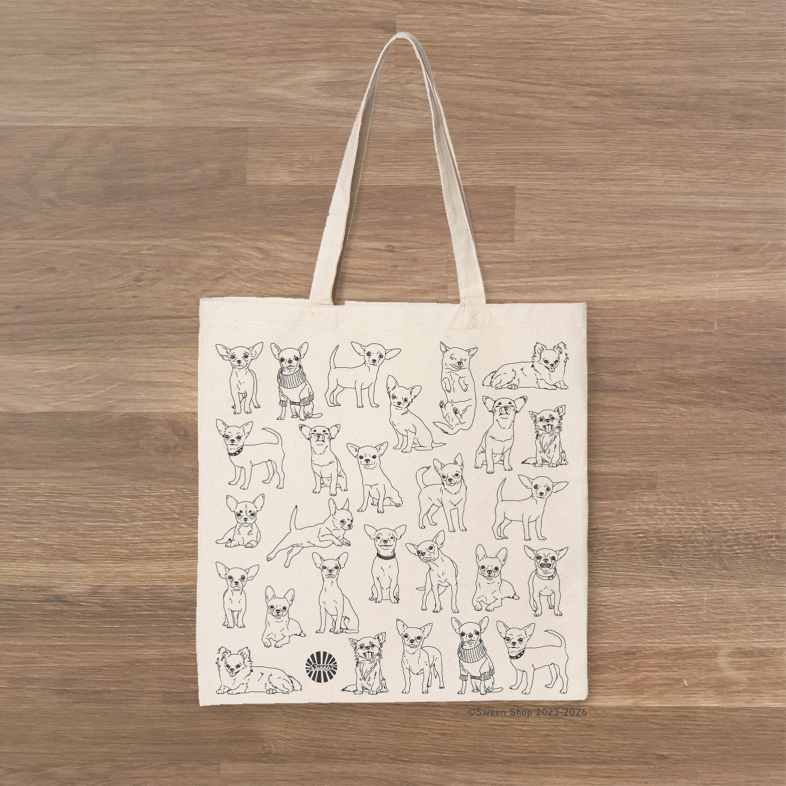 beige cotton canvas Tote bag with chihuahua pet dog illustrations on a wooden surface