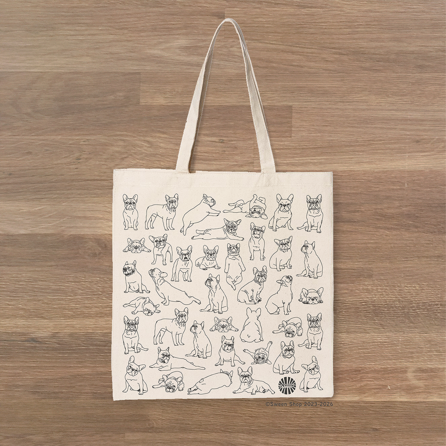 Tote bag with black line drawings of frenchie french bulldog pet dogs on a wooden surface
