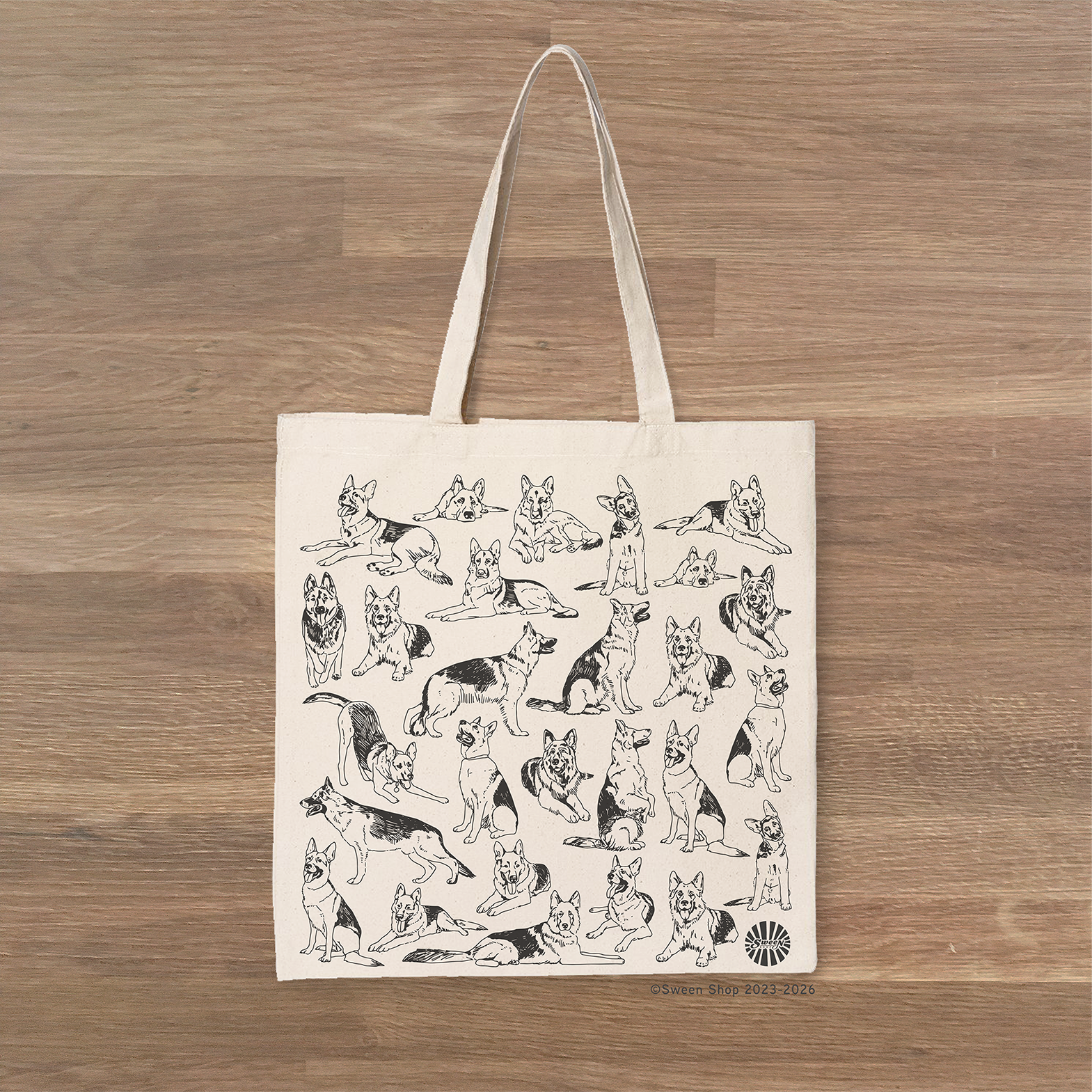 Tote bag with german shepherd pet dog illustrations on a wooden surface
