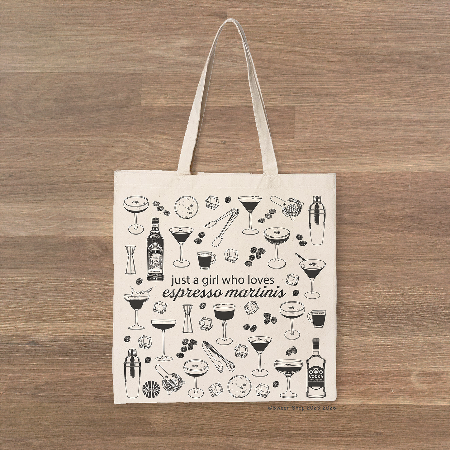 Cotton canvas Tote bag with espresso martini design on a wooden surface