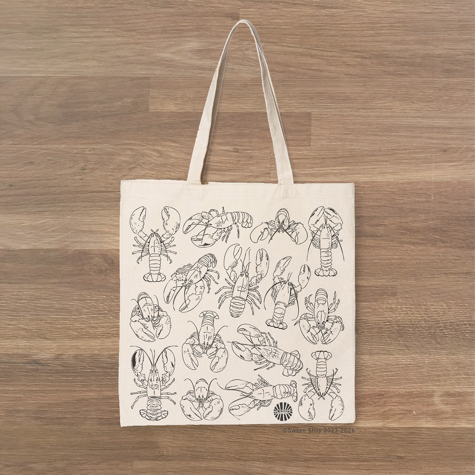 Tote bag with lobster pattern on a wooden surface