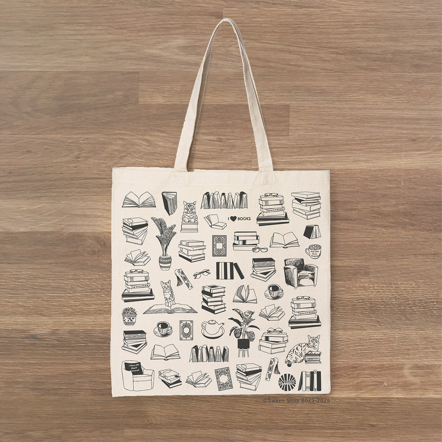 Tote bag with black books reading literary girl illustrations on a wooden surface