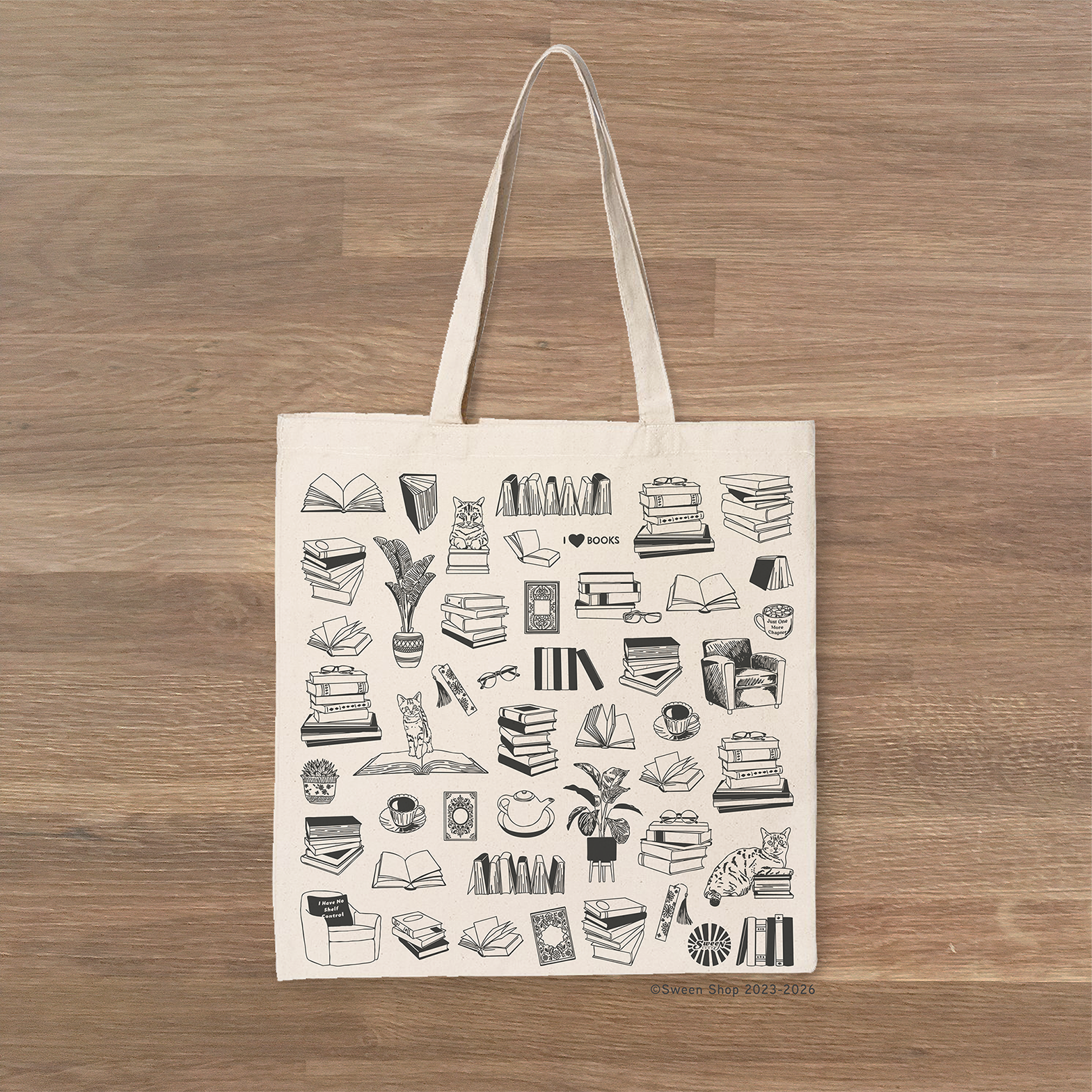 Tote bag with black books reading literary girl illustrations on a wooden surface