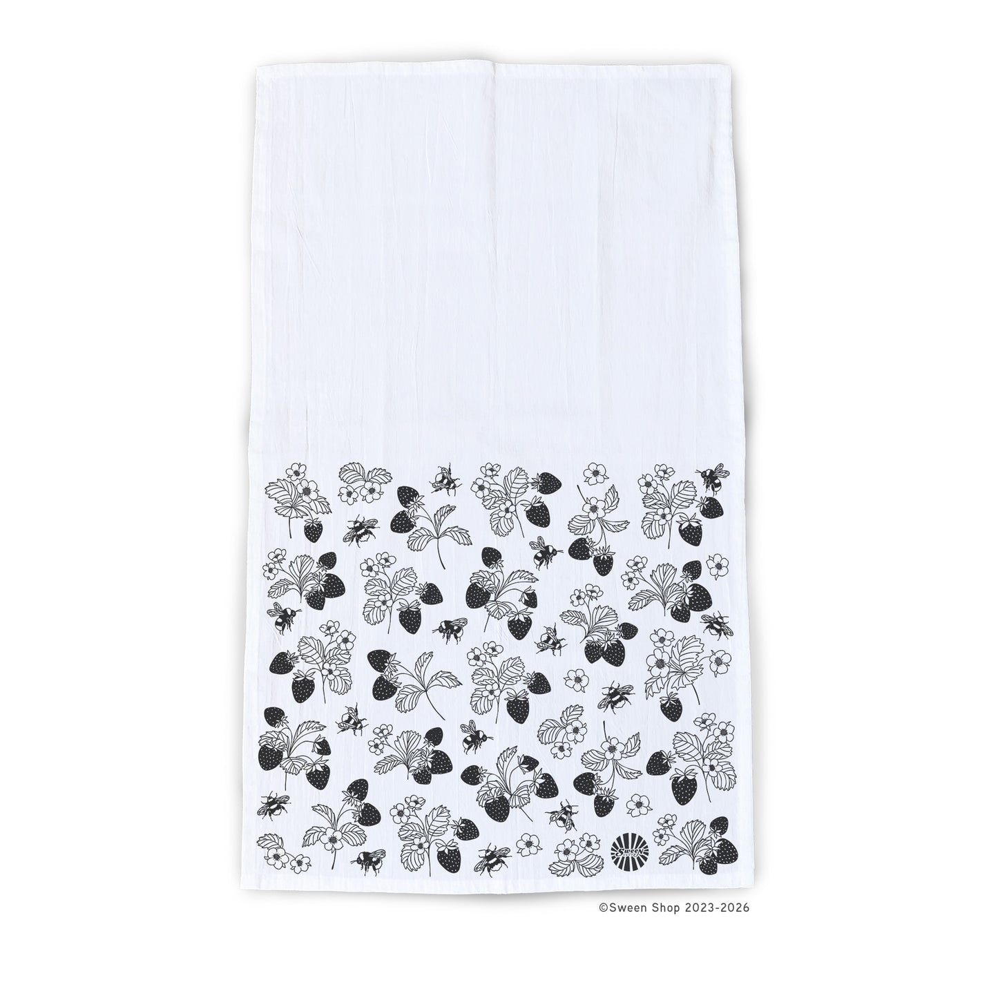 White kitchen towel with hand drawn black floral strawberry and bumble bee pattern on a white background
