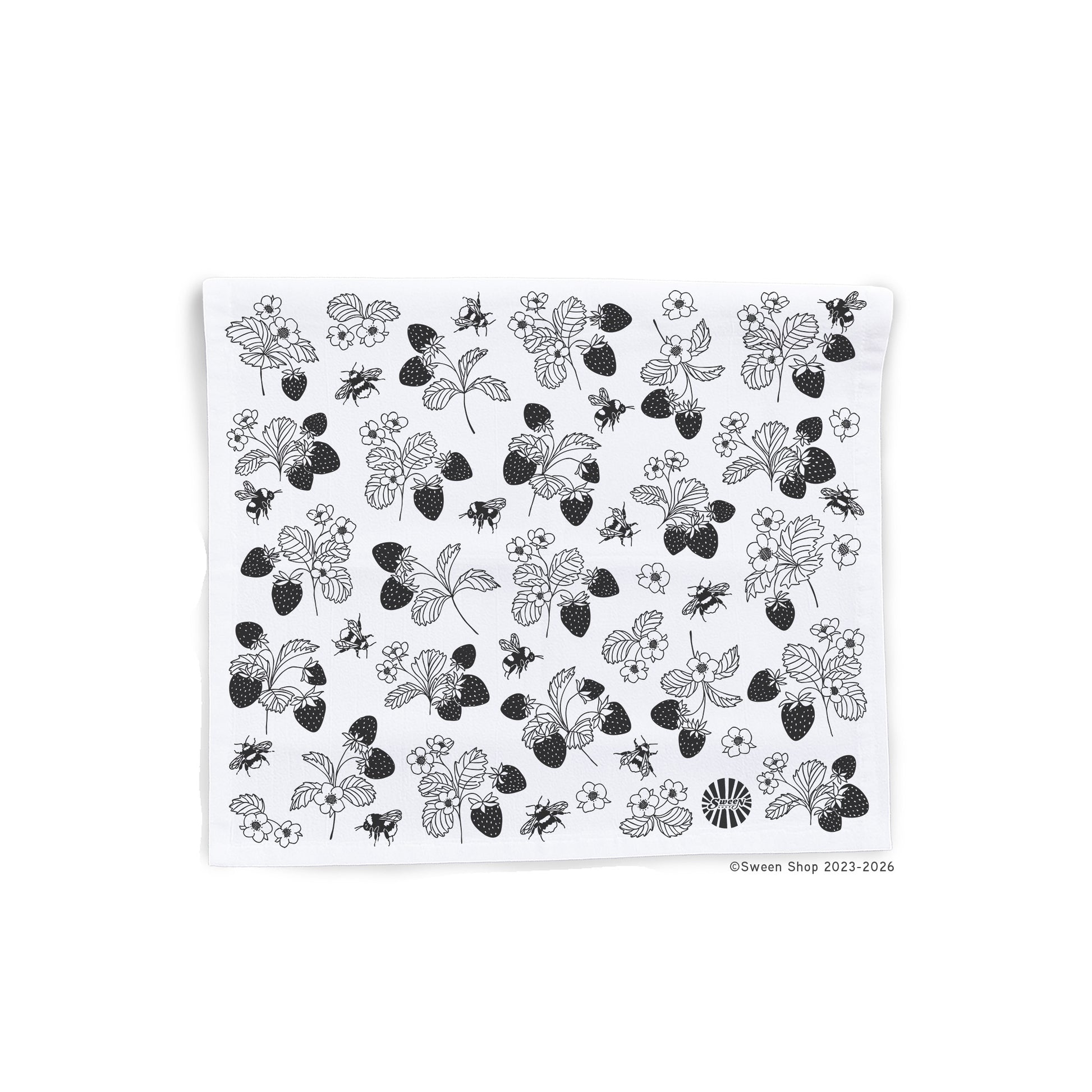 White kitchen towel with black floral strawberry and bumble bee pattern on a white background