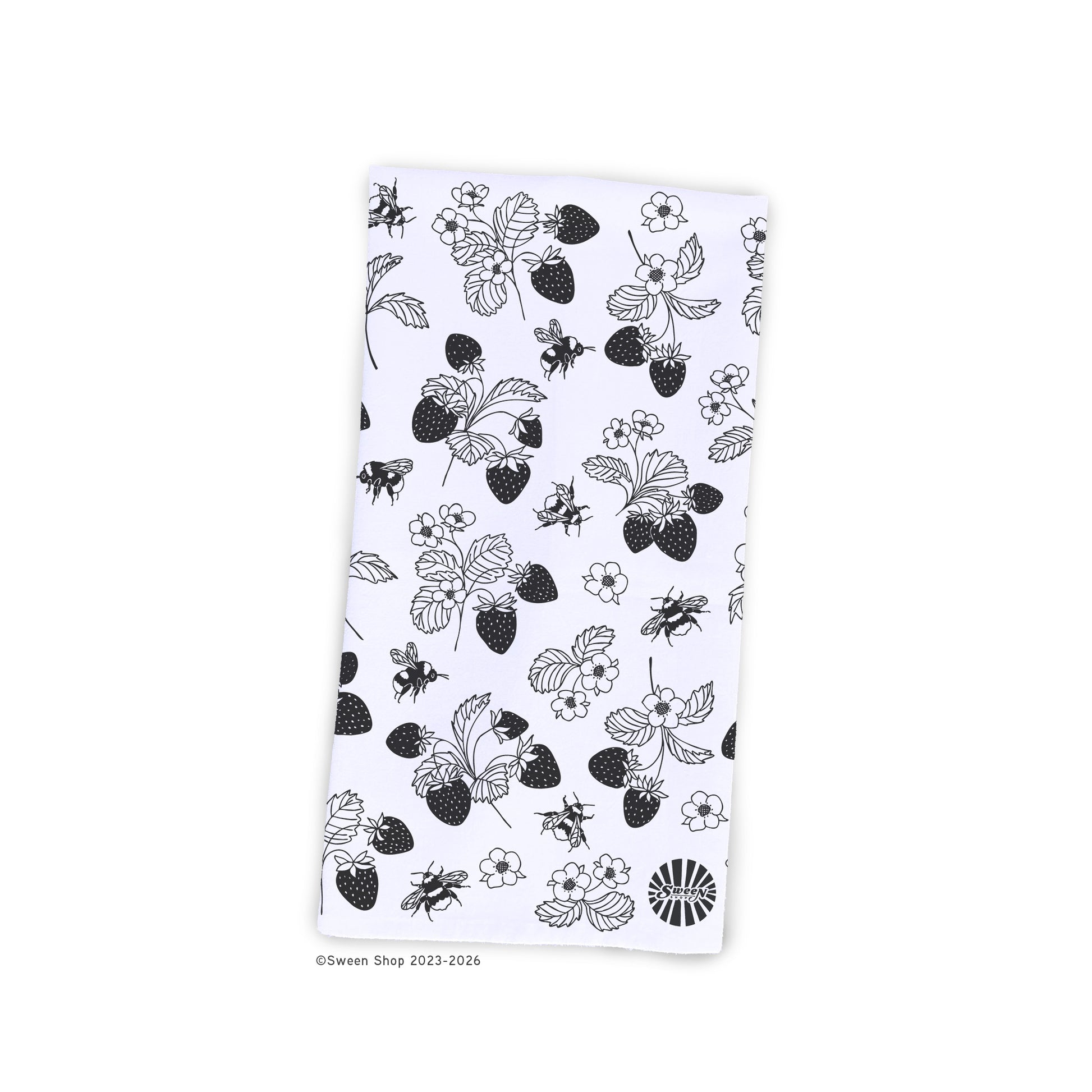 White kitchen towel with black strawberry and bee pattern on a white background