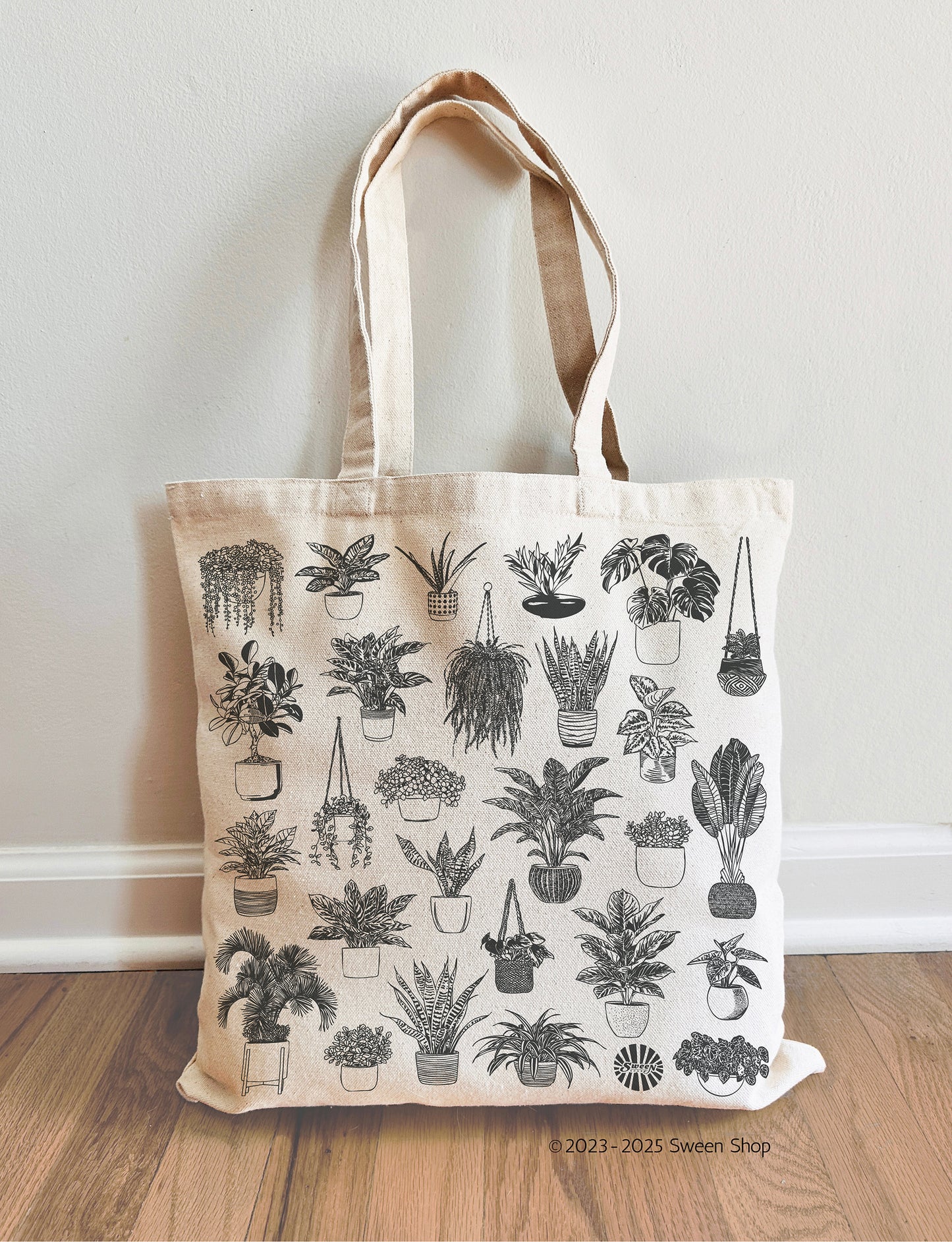 Tote bag with house plant pattern on a wooden floor